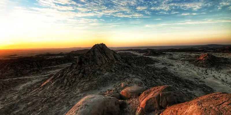 Panoramic sunset view overlooking the rocky granite peaks and desert valley landscape of Moon Valley near Jeddah.