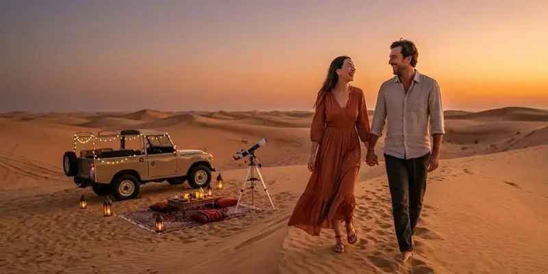 Hand-in-hand near a vintage SUV and telescope, a couple experiences the ultimate romantic Arabian desert excursion as the sun sets over the Jeddah dunes.